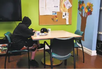  ?? Michael Short / Special to The Chronicle ?? A homeless youth eats lunch last month at the Bill Wilson Center’s drop-in center in San Jose.