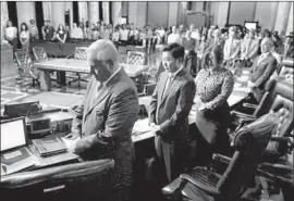  ?? Al Seib Los Angeles Times ?? CITY COUNCIL members observe a moment of silence to honor LAPD Officer Juan Jose Diaz, killed at a Lincoln Heights taco stand, and other shooting victims.