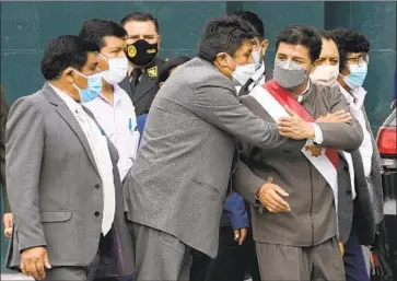  ?? Martin Mejia Associated Press ?? A LAWMAKER expresses his support for President Pedro Castillo, right, as he leaves Congress on Monday. The debate over his future comes as Peru has been seeing demonstrat­ions to protest food and fuel prices.