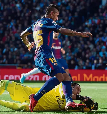  ??  ?? Beat you to it: Barcelona’s Paulinho in action against Real Madrid goalkeeper Keylor Navas during the Clasico at the Bernabeu on Saturday. — AFP