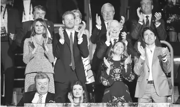  ??  ?? Ukrainian President Petro Poroshenko (first row, left) and his wife Maryna, Trudeau (first row, right) and his wife Sophie-Gregoire; (second row, from left) Melania, Prince Harry and Governor General of Canada David Johnston applaud during the opening...