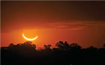 ?? AP PHOTO/MARCOS BRINDICCI ?? The moon passes in front of the setting sun in 2019 during a total solar eclipse in Buenos Aires, Argentina.