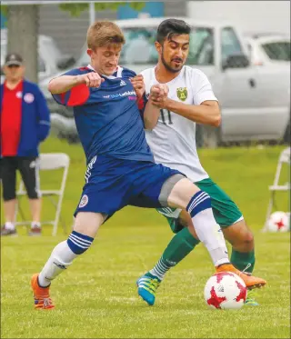  ?? Herald photo by Cam Yoos ?? Stephen Primeau of the LFC battles for the ball against Armaan Bhinder of the Edmonton Green and Gold during Alberta Major Soccer League action Saturday afternoon at the Servus Sports Centre. The teams tied 1-1.