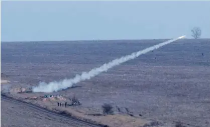  ?? Associated Press ?? Ukrainian soldiers launch anti-aircraft rockets during military exercises near Urzuf, south coast of Azov Sea, on Thursday.