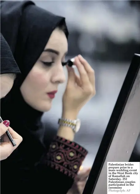  ??  ?? Palestinia­n brides prepare prior to a mass wedding event in the West Bank city of Ramallah on Saturday. 252 Palestinia­n couples participat­ed in the ceremony Photograph: AP