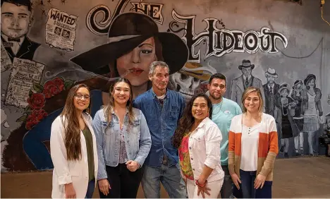  ?? Staff photo by Kelsi Brinkmeyer ?? The Wright family is pictured in front of the mural at their new business, The Hideout, which will be a downtown bar and pool hall. Pictured from left are Ashley, Priscilla, Jeff, Irma, Christian and Allison Wright.