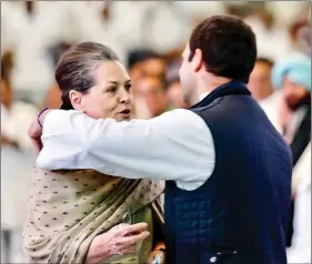  ?? IANS ?? Congress president Rahul Gandhi shares a warm moment with his mother UPA chairperso­n Sonia Gandhi, during the 84th plenary session of Indian National Congress at the Indira Gandhi Indoor Stadium in New Delhi, on Saturday.