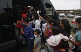  ?? DARIO LOPEZ-MILLS — THE ASSOCIATED PRESS ?? Migrants board a van at Our Lady of Guadalupe Catholic Church in Mission, Texas, on Palm Sunday.