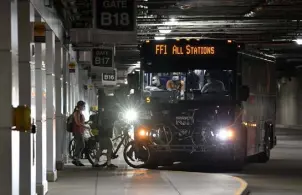  ?? Eric Lutzens, The Denver Post ?? Commuters board an RTD bus in the undergroun­d concourse at Union Station in downtown Denver in this July 2021 file photo.