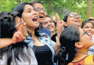  ?? PARVEEN KUMAR/HT PHOTO ?? A group of girls celebrate at a Gurgaon Sector 4 school on Sunday after the results of CBSE Class 12 board exams were declared. Overall, girls have managed to outshine boys yet again by a pass percentage difference of 9.5%.