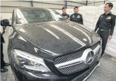  ??  ?? Authoritie­s inspect a warehouse in Samut Prakan where they found vehicles suspected to be linked to the import vehicle tax evasion network.