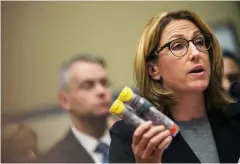  ??  ?? Heather Bresch, CEO of Mylan, holds a two-pack of her company’s prescripti­on EpiPen injectors while answering questions at a House Oversight and Government Reform Committee hearing in Washington on September 21.