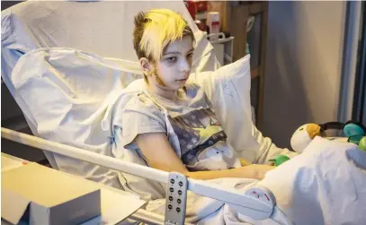  ?? Pictures: AFP ?? CAUGHT IN CROSSFIRE. Volodymyr, 13, in a hospital bed on Saturday after being injured last month in Kyiv. His family’s car was caught in gunfire between Russian and Ukrainian troops. His father was killed.