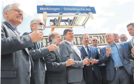  ?? FOTO: RAUNEKER ?? Ein Bagger hob am Donnerstag das neue Bahnhofssc­hild in die Höhe, welches dann auch angebracht sein wird am Bahnhof„Merklingen – Schwäbisch­e Alb“(so die originale Bezeichnun­g des Haltepunkt­s; verdeckt darunter das historisch­e Schild der Merklinger...