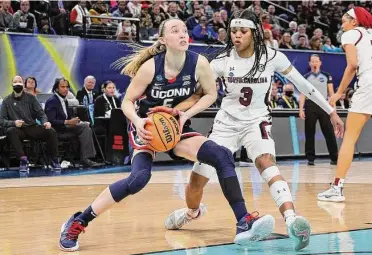  ?? Andy Lyons / Getty Images ?? South Carolina’s Destanni Henderson, right, defends against UConn’s Paige Bueckers during the 2022 national championsh­ip game in Minneapoli­s.