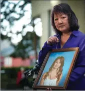  ?? The Canadian Press file photo ?? Carol Todd holds a photo of her late teenage daughter Amanda Todd, who died by suicide in 2012 after being extorted online by a man in Europe. The New Westminste­r mother has been an advocate against cyberbully­ing and encourages parents to educate themselves on the dangers that can occur online.