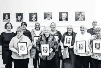  ??  ?? Snap happy The women pose for a group shot at the new exhibition, with Councillor John Anderson