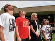  ?? SUBMITTED PHOTO — COURTESY OF GWYNEDD MERCY UNIVERSITY ?? Gwynedd Mercy University President Deanne H. D’Emilio, third from left, views the solar eclipse Monday with GMercyU students.