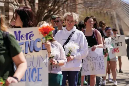  ?? Photograph: Dieu-Nalio Chery/Reuters ?? Michigan State students march to protest gun violence. The police said ‘there is no conclusive motive’ as to why the attacker targeted the university.