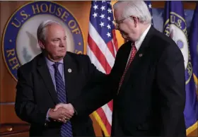  ?? J. SCOTT APPLEWHITE / AP ?? Rep. Mike Doyle, D-PA., left and Rep. Joe Barton, R-texas, managers of the congressio­nal baseball teams, shake hands during a news conference Wednesday on Capitol Hill.