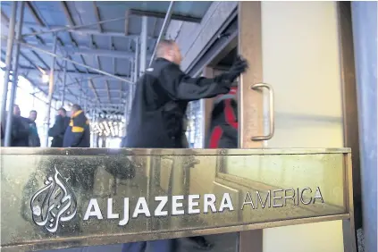  ?? AFP ?? People walk into the broadcast centre of Al-Jazeera America in New York on Wednesday.