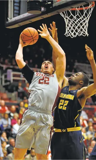  ?? JIM GENSHEIMER/STAFF ?? Stanford’s Reid Travis shoots against Cal’s Kingsley Okoroh during Friday’s Cardinal victory at Maples Pavilion.