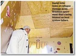  ??  ?? Daniel Jeter looks at collapse damage in his Brooklyn apartment that’s being blamed on heat system failure.