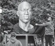  ?? John Minchillo / Associated Press ?? A sculpture of George Floyd is unveiled at Union Square in New York City. Three days later, it would be defaced, a heartbreak­ing example of hate.