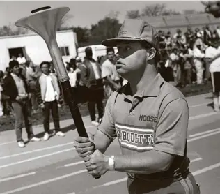  ?? Charles Cherney / Associated Press ?? In May 1988, Michael Cusack carried the torch around the track at the University of Chicago’s Stagg Field during the Special Olympics opening ceremony. He has died at age 64.