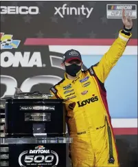  ?? JOHN RAOUX — THE ASSOCIATED PRESS ?? Michael McDowell celebrates after winning Sunday’s NASCAR Daytona 500. McDowell, a 100-1underdog, pulled into the lead on the final lap for his first NASCAR Cup Series win in 358tries.