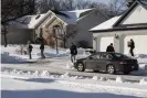  ?? Photograph: Matthew Dae Smith/AP ?? Law enforcemen­t personnel leave the home of former US Olympic women’s gymnastics coach John Geddert in January.