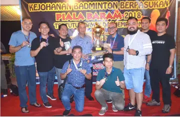  ??  ?? Penguang (standing, fourth left) presents a trophy and other prizes to members of SeTech-Baram Youth A, who emerged overall champions in the men’s category of the competitio­n.