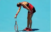  ??  ?? Kristina Mladenovic of France succumbs to the heat in her first-round match in Sydney.