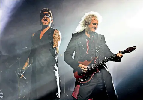  ??  ?? The show goes on: Adam Lambert, the 35-year-old runner-up of American Idol in 2009, with 70-year-old Brian May on stage as Queen perform at the O2 in London