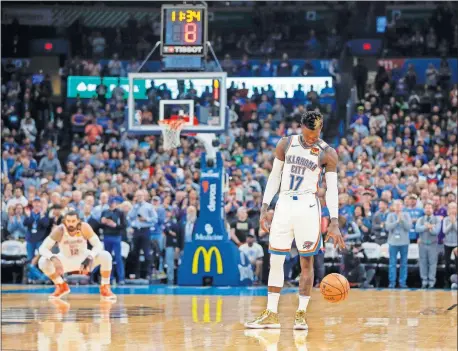  ??  ?? Oklahoma City's Dennis Schroder, right, dribbles the ball before taking a 24-second violation to honor NBA legend Kobe Bryant. Bryant, who died Sunday in a helicopter crash, wore jersey No. 24 for part of his NBA career with the Los Angeles Lakers. [NATE BILLINGS/ THE OKLAHOMAN]