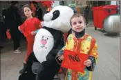  ?? ZHAO DINGZHE / XINHUA ?? From top: Children pose with the Chinese character “fu”, which means “good fortune”, during a cultural event at the University of Luxembourg on Jan 28.