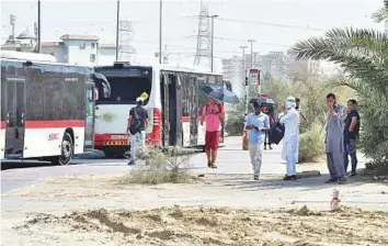  ?? Clint Egbert/Gulf News ?? There are eight bus routes serving Internatio­nal City, but no covered bus shelters. Commuters with respirator­y problems are most affected by having to wait for a bus in the heat and dust.