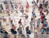  ?? LM OTERO/AP ?? Plastic glass keeps travelers separated as they line up Friday to clear security at Love Field in Dallas.