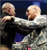  ?? AP/ISAAC BREKKEN ?? Floyd Mayweather Jr. (left) and Conor McGregor embrace Sunday during a news conference after a super welterweig­ht boxing match in Las Vegas.