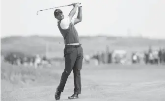  ??  ?? Tiger Woods plays a shot on the 7th fairway during the third round of the British Open in Carnoustie, Scotland, on Saturday.