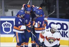  ?? NATHAN DENETTE - THE ASSOCIATED PRESS ?? New York Islanders left wing Matt Martin (17) celebrates his goal with teammates as Florida Panthers defenceman Keith Yandle (3) skates away during the second period of an NHL Stanley Cup playoff hockey game in Toronto, Tuesday, Aug. 4, 2020.