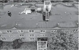  ?? TIM KROCHAK ■ THE CHRONICLE HERALD ?? The remains of a collapsed chimney lie next to a roofless elevator hoistway on the roof of a Lawrence Street apartment building in Dartmouth last week.