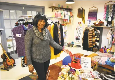  ?? Alexander Soule / Hearst Connecticu­t Media ?? Jean Smith displays a “Santa” bag for wine, candles and other holiday gifts, on Wednesday at her Jean’s Closet shop at 129A Washington St. in South Norwalk.