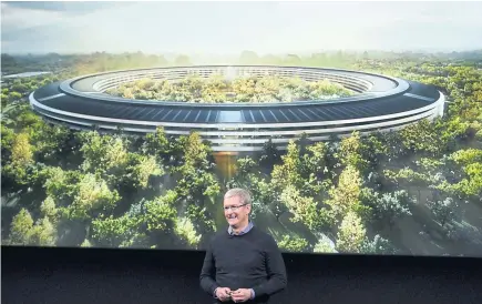  ?? AFP ?? Apple CEO Tim Cook stands in front of a slide of the company’s new campus which is under constructi­on during a media event at Apple headquarte­rs in Cupertino, California on March 21, 2016.