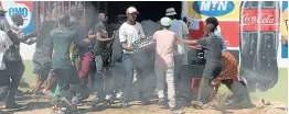  ?? Picture: THULANI MBELE ?? PANDEMONIU­M: Residents of White City Jabavu in Soweto looted foreign-owned shops last month after raising concerns that the traders sold illegal grocery items.