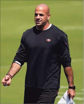  ?? Jeff Chiu / Associated Press ?? San Francisco 49ers defensive coordinato­r Robert Saleh watches during practice in September. Saleh, the New York Jets’ new head coach, has families in neighborho­ods all across the country celebratin­g the first known Muslim American to hold that position in NFL history. That’s a source of great pride for a community that has been generally underrepre­sented in the league’s on-field leadership roles.