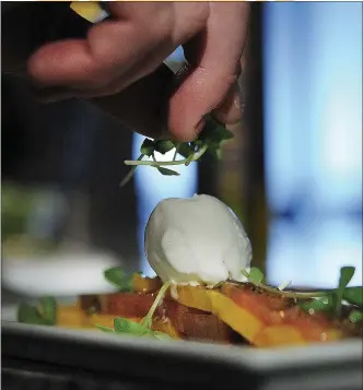  ?? CINDY YAMANAKA — STAFF PHOTOGRAPH­ER ?? Chef Rob Wilson tops Crème Fraiche Sorbet with micro basil in this delicious summer dish.