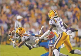  ?? GERALD HERBERT/AP PHOTO ?? LSU safety Grant Delpit breaks up a pass intended for Florida wide receiver Freddie Swain on Saturday in Baton Rouge, La. The Tigers won 42-28.