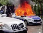  ?? AP ?? A Kosovar police car burns in Zvecan, Kosovo, on Friday after clashes between police and ethnic Serbs.