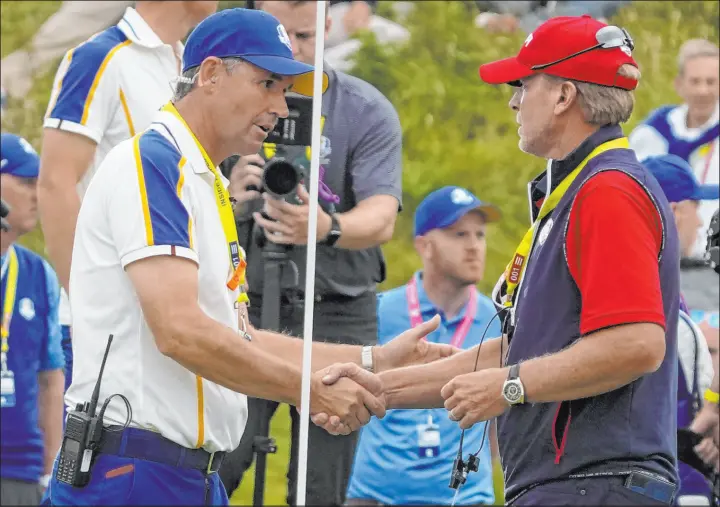  ?? Charlie Neibergall The Associated Press ?? American captain Steve Stricker, right, and European captain Padraig Harrington shake hands after Sunday’s final session of the Ryder Cup at Whistling Straits.